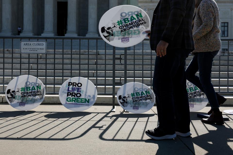 Director of the Christian Defense Coalition Rev. Patrick Mahoney sets signs up in front of the U.S. Supreme Court Building on April 19, 2023 in Washington, DC.