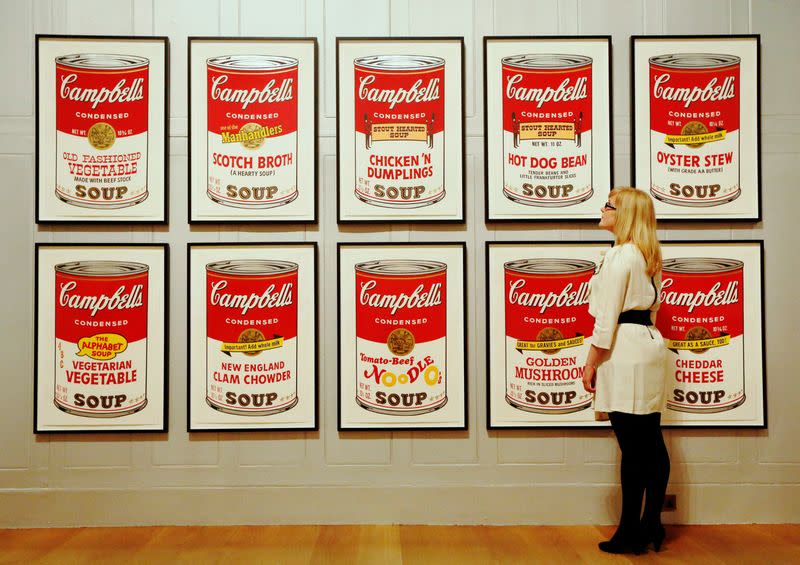 FILE PHOTO: Gallery employee Maddy Adeane poses with Andy Warhol's "Campbell's Soup II" (1969) at the Dulwich Picture Gallery in London