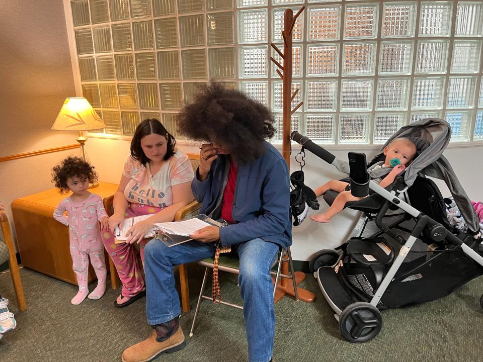 Rebecca Adamson and Chris Watkins fill out forms before their treatment as their daughter Keiko and son Lucas hang out at Dr. Kavin Kelp's office.