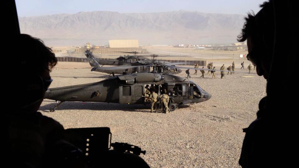 Soldiers get into a helicopter.