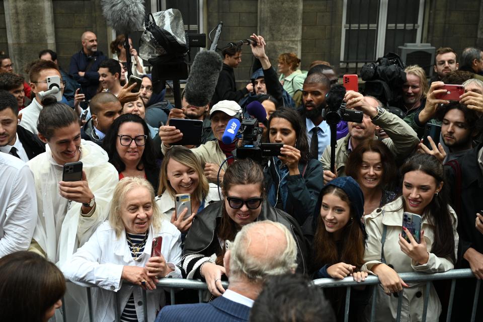 The rain hasn’t put off visitors who line the streets around the Notre Dame to welcome the royals (Daniel Leal/PA Wire)