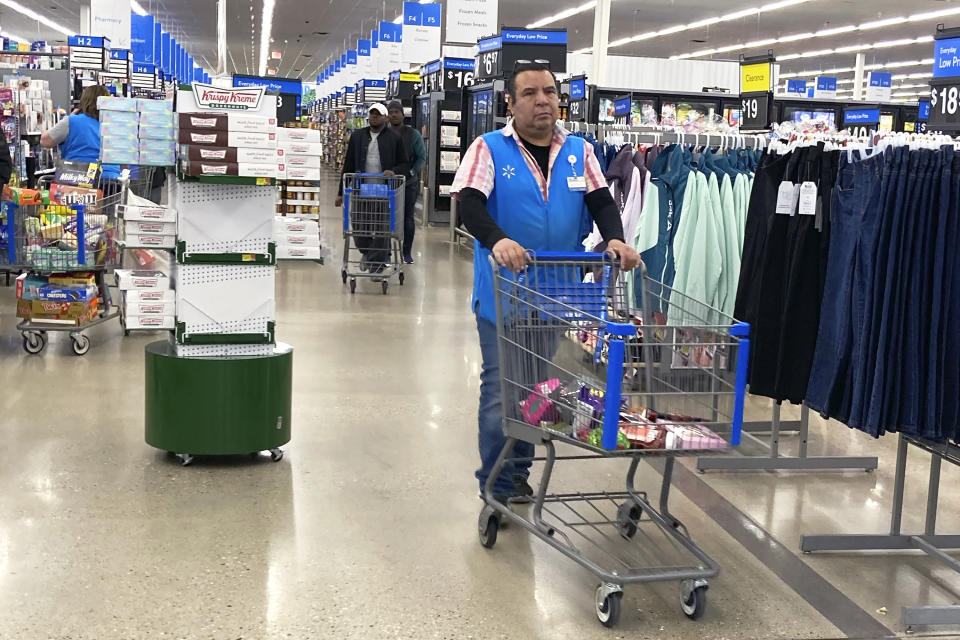 File - A employee pushes a cart at a Walmart in Vernon Hills, Ill., Tuesday, March 28, 2023. On Friday, the U.S. government issues the June jobs report. (AP Photo/Nam Y. Huh, File)
