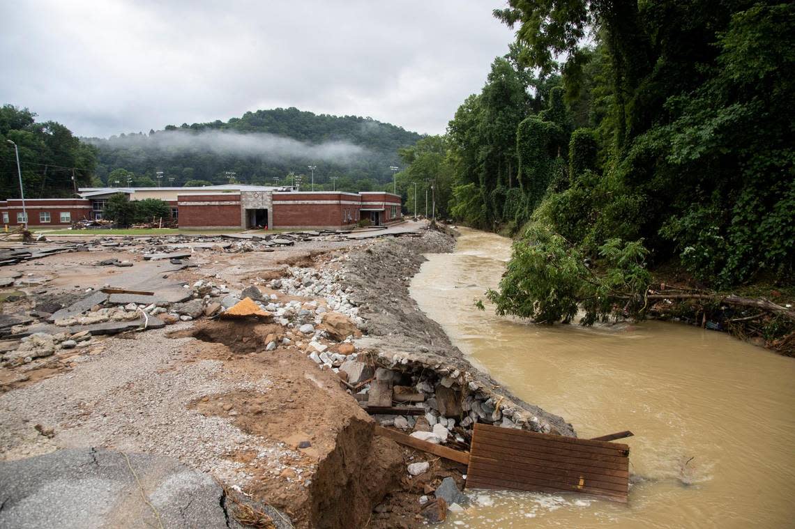 The road and parking lot for the Buckhorn School sit extremely damaged after flooding swept through Buckhorn in Perry County, Ky., Friday, July 29, 2022.
