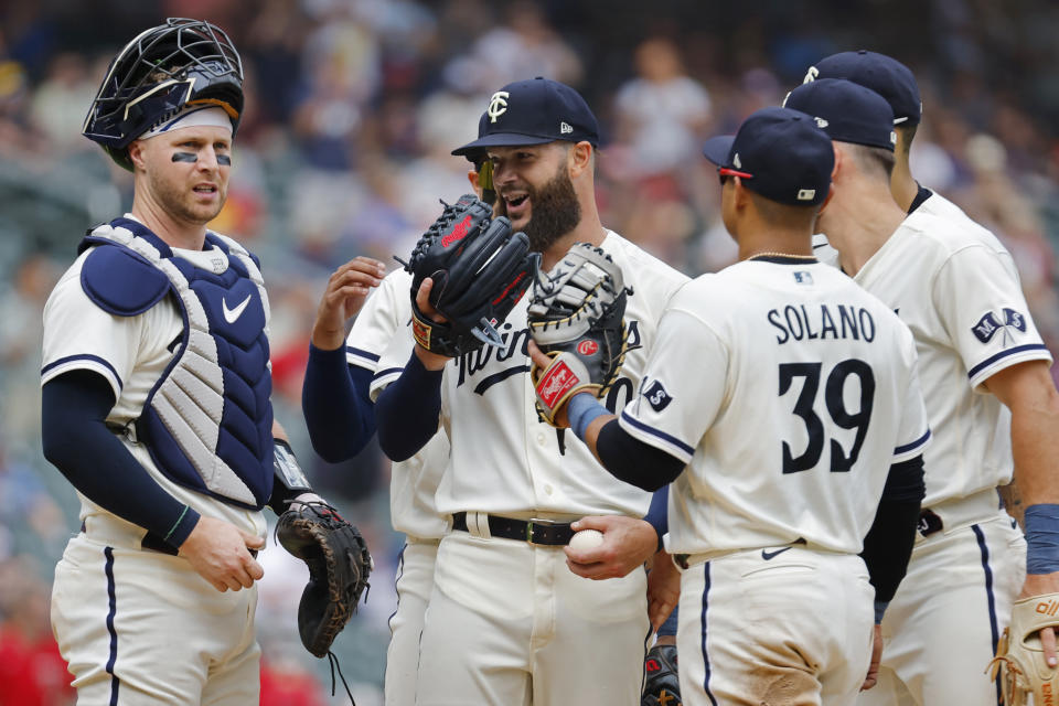 Minnesota Twins starter Dallas Keuchel, center, celebrates with teammates after giving up a double to Pittsburgh Pirates' Bryan Reynolds following six and 1/3rd perfect innings of pitching in the seventh inning of a baseball game Sunday, Aug. 20, 2023, in Minneapolis. (AP Photo/Bruce Kluckhohn)