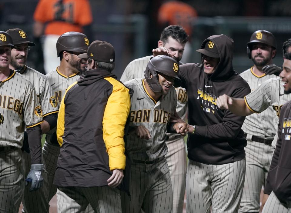 San Diego's Trent Grisham, center, celebrates with his teammates after hitting the game-winning home run.