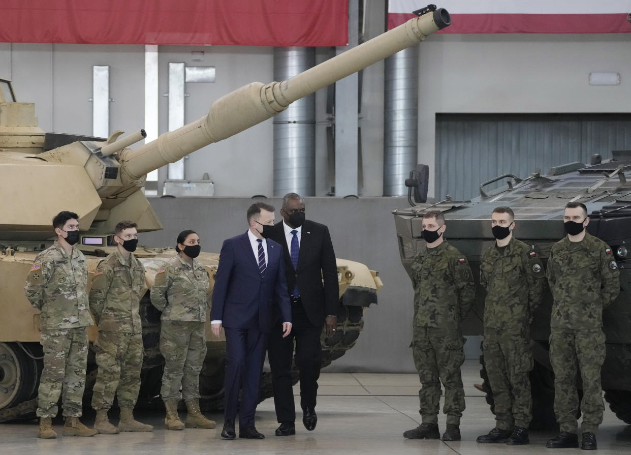 U.S. Defense Secretary Lloyd Austin, centre, and Poland's Defense Minister Mariusz Blaszczak walk, during a visit to U.S. troops stationed at the Powidz Air Base, in Poland, Friday, Feb. 18, 2022. Austin is in Europe for talks among fears in the West that Russia is planning to invade Ukraine, which borders NATO and European Union member Poland. (AP Photo/Czarek Sokolowski)