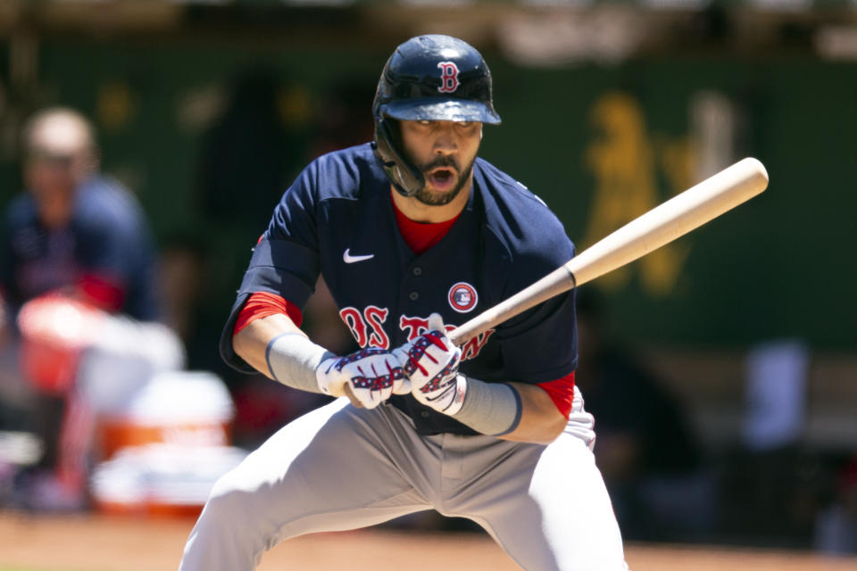 Boston Red Sox's Marwin Gonzalez (12) reacts to being called out on strikes during the second inning of a baseball game against the Oakland Athletics, Sunday, July 4, 2021, in Oakland, Calif. (AP Photo/D. Ross Cameron)