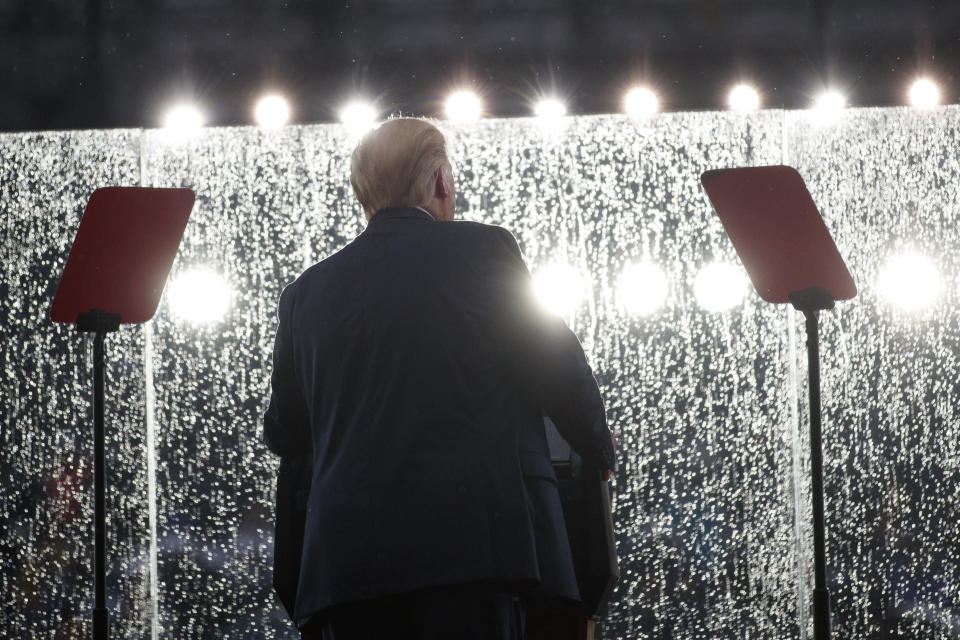 President Donald Trump speaks in the rain behind glass during an Independence Day celebration in front of the Lincoln Memorial, Thursday, July 4, 2019, in Washington. (AP Photo/Carolyn Kaster)