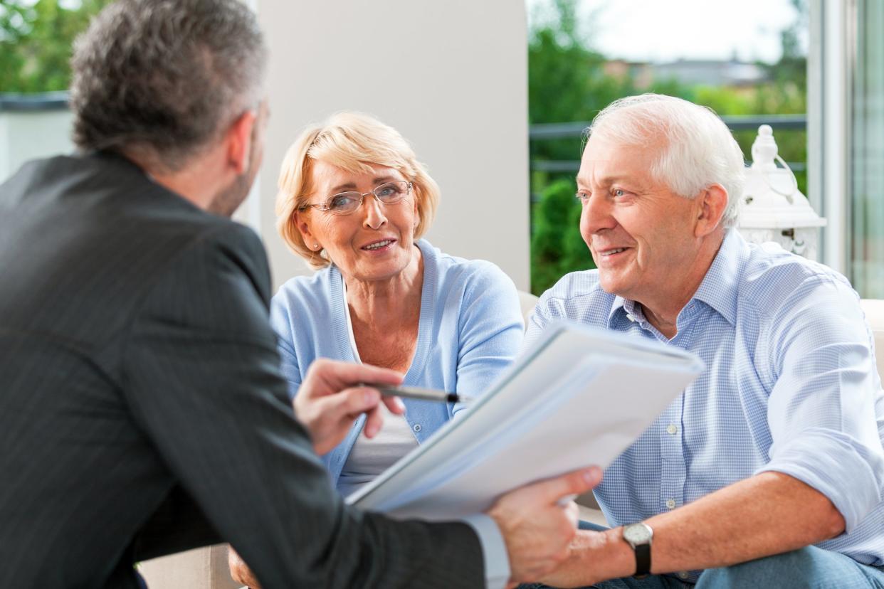 senior couple talking with financial advisor