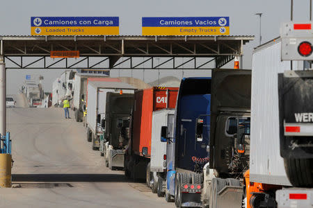 FILE PHOTO: Trucks wait in a long queue for border customs control to cross into the U.S. at the Otay border crossing in Tijuana, Mexico, February 2, 2017. REUTERS/Jorge Duenes/File Photo