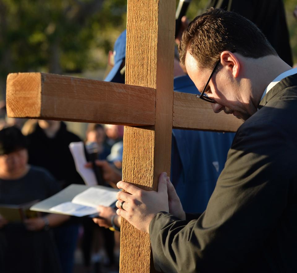 Rev. David Svihel of Church of the Redeemer prays at the 7th Station of the Cross during the annual pilgrimage last year in downtown Sarasota.