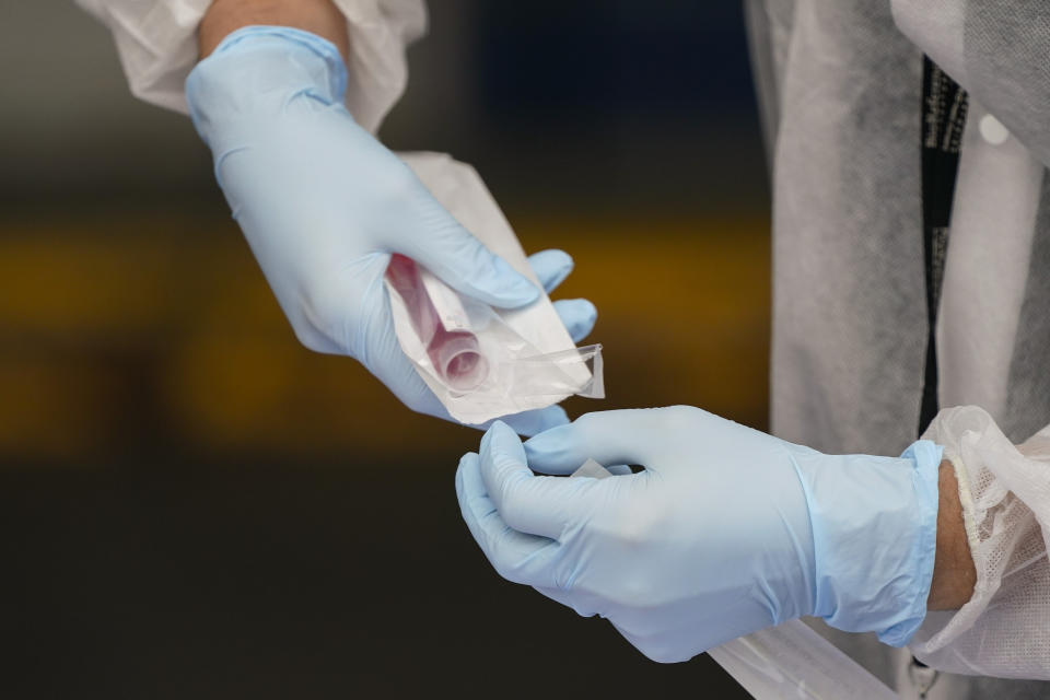 A Medical Assistant administers a Covid test as part of plans by the Metropolitan Transportation Authority to test workers Tuesday, Oct. 27, 2020, at the Grand Avenue Bus Depot in New York. (AP Photo/Frank Franklin II)