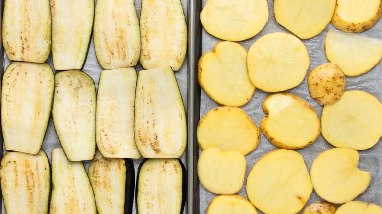 Sliced eggplants and potatoes on baking sheets