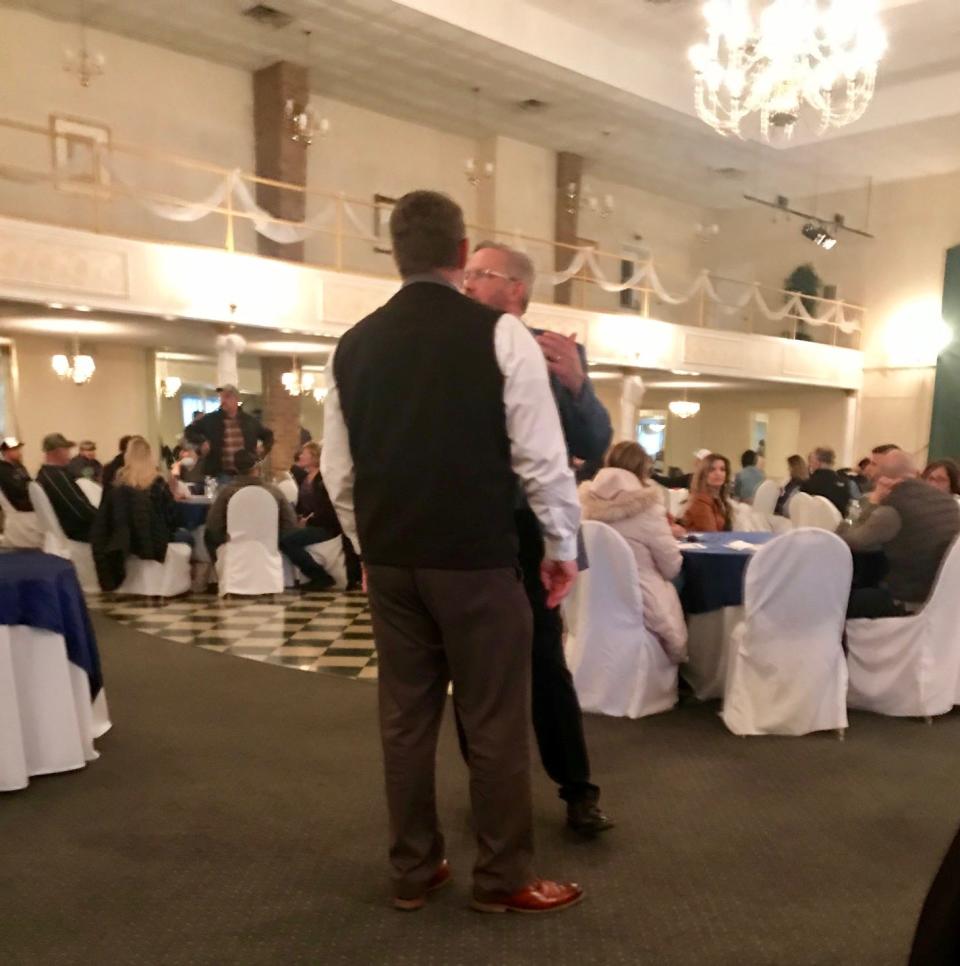 State Rep. Mike Jones, R-York Township, right, talks to an attendee of a meeting Jones held at Wisehaven Event Center Saturday, May 9. More than 150 mostly maskless people attended the meeting about reopening business, despite state rules forbidding large gatherings because of the the COVID-19 pandemic.