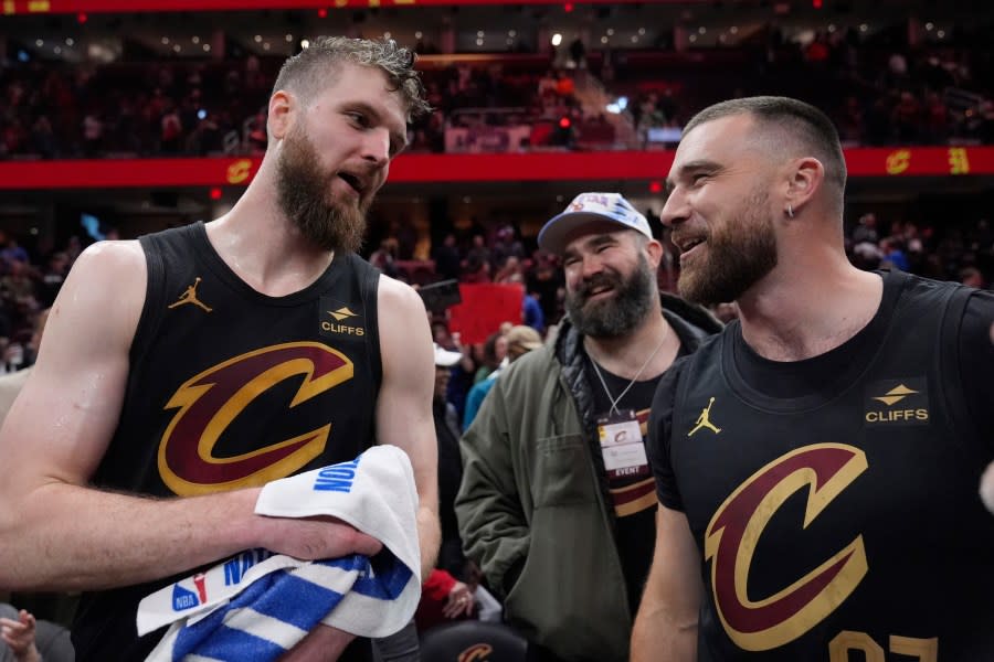 Cleveland Cavaliers forward Dean Wade, left, celebrates with Jason Kelce, center, and Travis Kelce, right, after the Cavaliers defeated the Boston Celtics in an NBA basketball game, Tuesday, March 5, 2024, in Cleveland. (AP Photo/Sue Ogrocki)