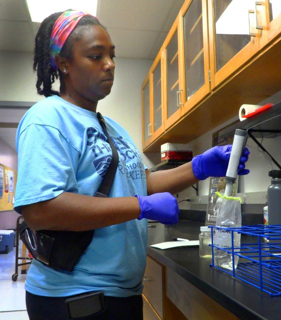 Vanisha Estrahota, Columbus technical programs fellow, tests a water sample she collected from the Chattahoochee River near the outfall pipe for Phenix City, Alabama’s wastewater treatment plant. 07/10/2024