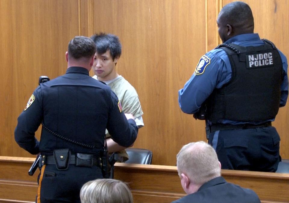 A Monmouth County Sheriff's Officer tries to calm former Colts Neck tennis instructor Terry Kuo during his sentencing for his identity theft case before Superior Court Judge Marc C. Lemieux in Freehold Tuesday, April 16, 2024.