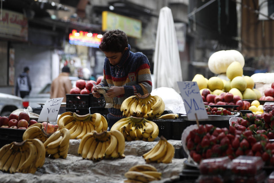 Shopkeeper waits for customers in Damascus, Syria, Sunday, Dec. 15, 2022. Syria's economy has hit its lowest point since the country's civil war began nearly 12 years ago, with severe fuel shortages in both government and rebel-held areas, spiraling inflation and the Syrian currency hitting an all-time low on the black market. (AP Photo/Omar Sanadiki)