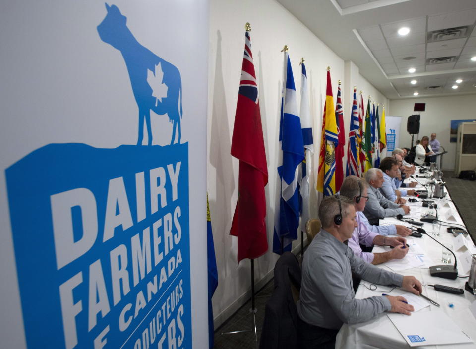 FILE - In this Sept. 19, 2018, file photo, members of the Dairy Farmers of Canada hold a news conference in Ottawa, Ontario. American dairy farmers get more access to the Canadian market. U.S. drug companies can fend off generic competition for a few more years. Automakers are under pressure to build more cars where workers earn decent wages. (Adrian Wyld/The Canadian Press via AP, File)