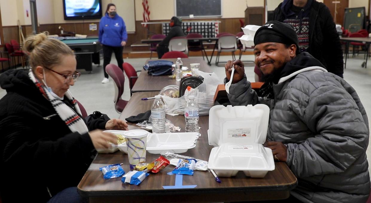 Carlos Bryant and Melissa Wikander share a hot meal Nov. 23, 2020, in the warming center run by Just Believe Inc. at the Toms River recreation building at Riverwood Park.