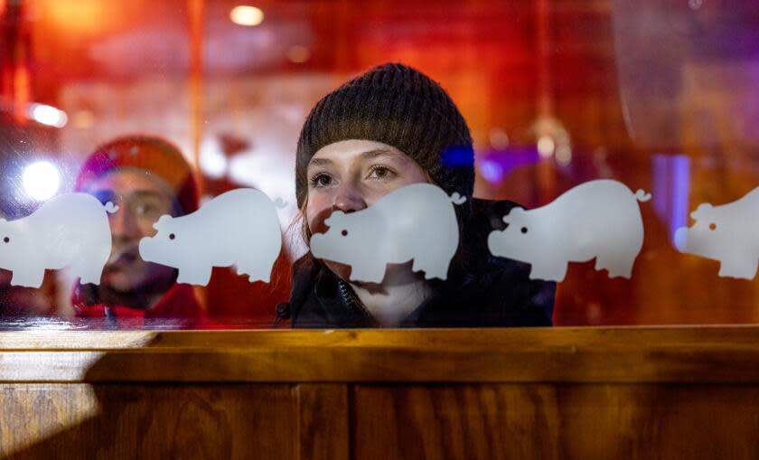 AMES, IOWA - JANUARY 14, 2024: A young Iowan watches through a glass window during a campaign event for hear Nikki Haley at Jethro's BBQ the day before the Iowa Caucus on January 14, 2024 in Ames, Iowa. The voting population in in Iowa mostly white. Nearly, 84% of the Hawkeye states residents are non-Latino whites. Not exactly a representation of the rest of the country.(Gina Ferazzi / Los Angeles Times)