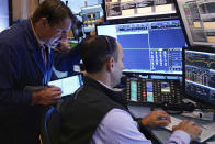 Trader Michael Milano. left, works with colleagues on the floor of the New York Stock Exchange, Wednesday, Aug. 7, 2024. (AP Photo/Richard Drew)