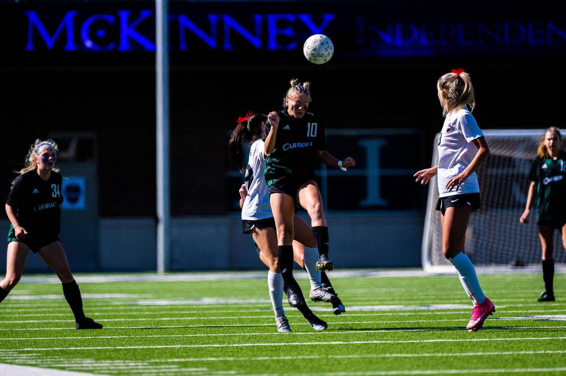 Kennedy Fuller (10) headbutts the ball during the 6A Regional Final between the Carroll Lady Dragons and the Marcus Marauders at McKinney ISD Stadium on April 9th, 2022.