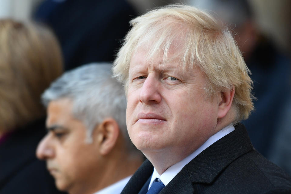 London mayor Sadiq Khan (L) and Britain's Prime Minister Boris Johnson take part in a vigil at the Guildhall in central London to pay tribute to the victims of the London Bridge terror attack on December 2, 2019. (Photo by DANIEL LEAL-OLIVAS / AFP) (Photo by DANIEL LEAL-OLIVAS/AFP via Getty Images)