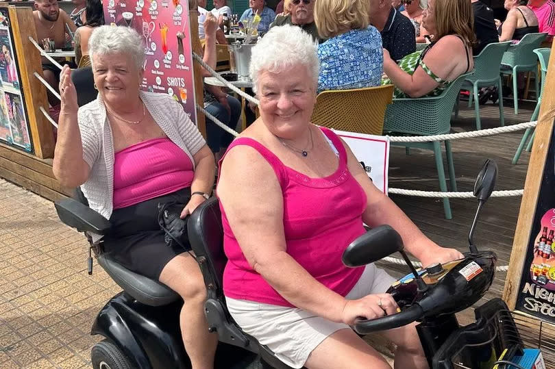 Gill and Mo on a tandem mobility scooter