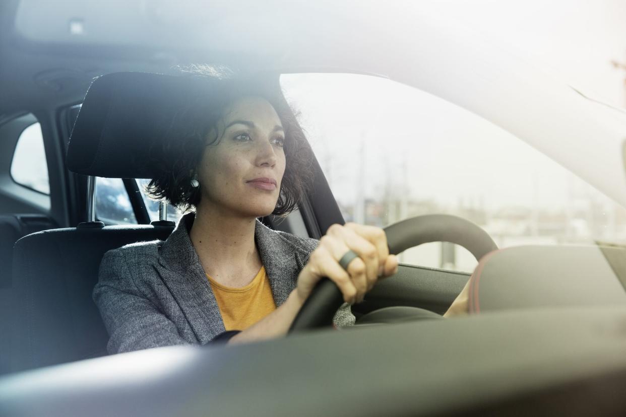 alert woman driving car