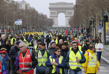 Protesters wearing yellow vests walk down the Champs Elysees during a demonstration by the "yellow vests" movement in Paris, France, March 9, 2019. REUTERS/Philippe Wojazer