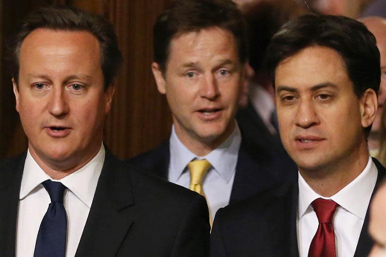 A file picture taken on June 4, 2014, shows British Prime Minister David Cameron (L) and leader of the opposition Labour Party Ed Miliband (R) and British Deputy Prime Minister Nick Clegg (C) during the State Opening of Parliament in London