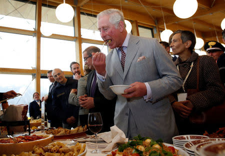 Britain's Prince Charles tastes Gricia's pasta dish during his visit to the town of Amatrice, which was levelled after an earthquake last year, in central Italy April 2, 2017. REUTERS/Alessandro Bianchi