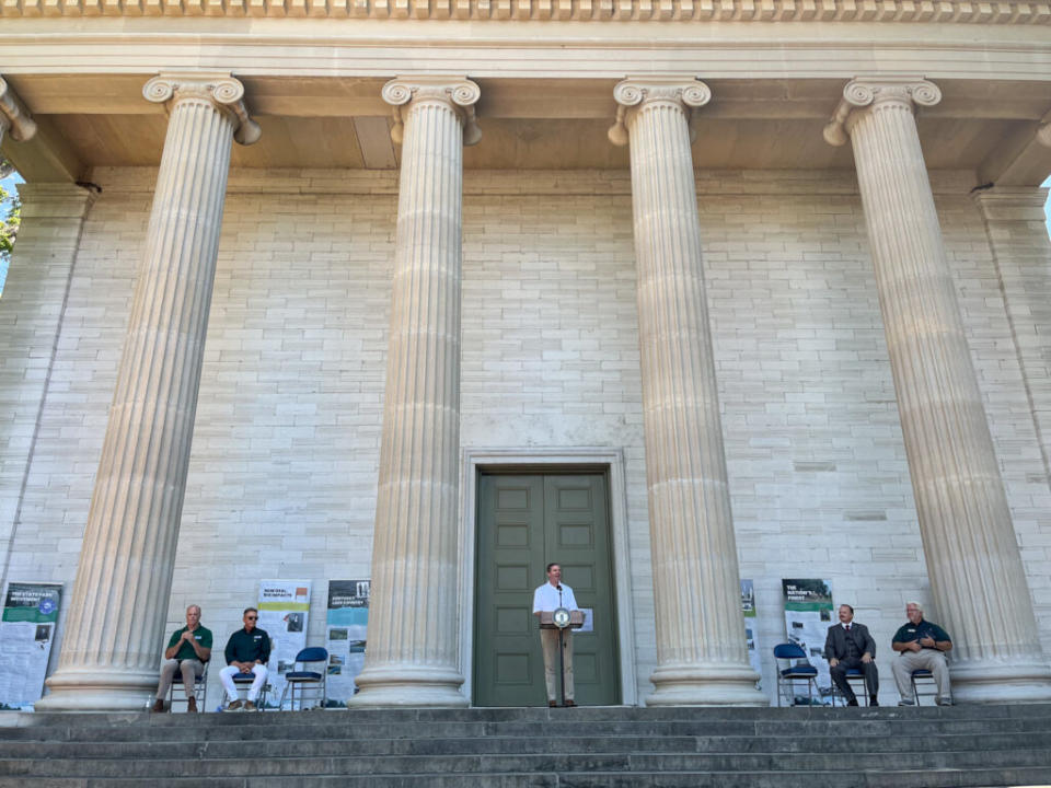  Gov. Andy Beshear addresses a crowd outside the Old State Capitol in Frankfort to honor Kentucky State Parks’ 100th anniversary. (Kentucky Lantern photo by McKenna Horsley)