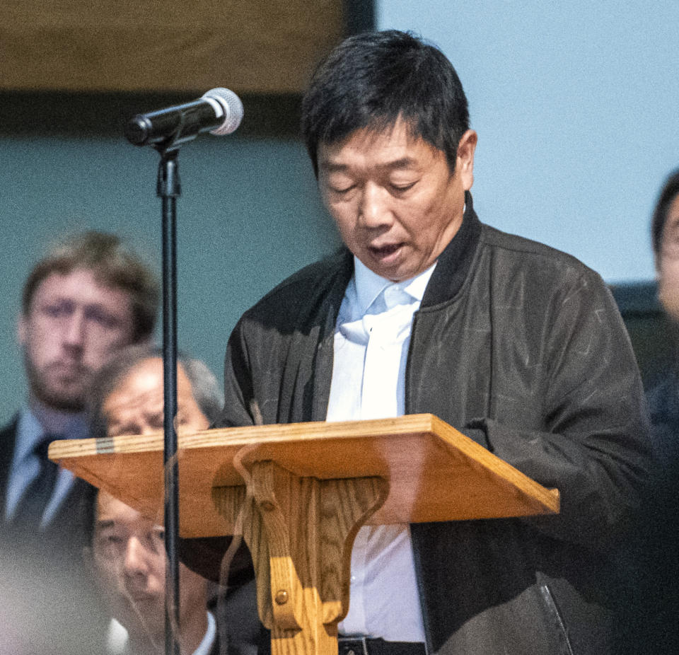 Ronggao Zhang gives the eulogy for his daughter, Yingying during a memorial service for her, Friday, Aug. 9, 2019 at the First Baptist Church in Savoy, Ill. The family of Yingying Zhang, a Chinese scholar whose body was never recovered after her 2017 slaying gathered at a memorial service that included only her photograph and their own memories of her life. (Robin Scholz/The News-Gazette via AP)