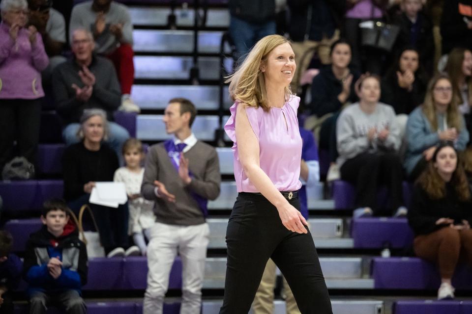 Amy O'Brien Davagian walks onto the court during Saturday's ceremony retiring the numbers of former Holy Cross female basketball players.