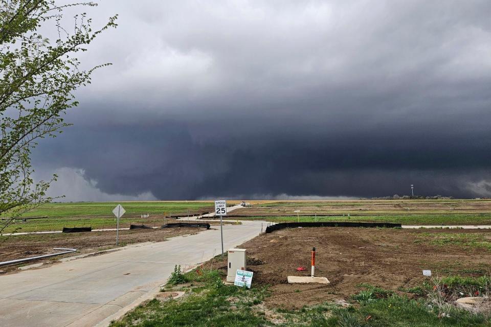 Heavy storm clouds appear as a tornado moves through suburbs northwest of Omaha on Friday, April 26, 2024, as seen from Bennington, Neb. (Chris Gannon via AP)