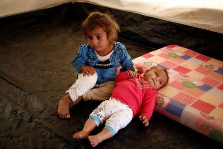 Farah (L), 2, and Maha, 8 months old, who were both born under Islamic State rule and have no identity documents recognised by Iraqi authorities, are seen inside their parents' tent in Debaga refugee camp, Iraq November 10, 2016. REUTERS/Zohra Bensemra