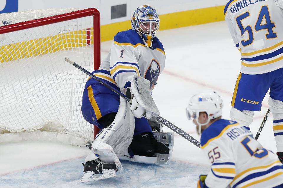 Buffalo Sabres' Ukko-Pekka Luukkonen (1) catches his left leg on the post during the second period of an NHL hockey game against the Boston Bruins, Saturday, May 1, 2021, in Boston. (AP Photo/Michael Dwyer)