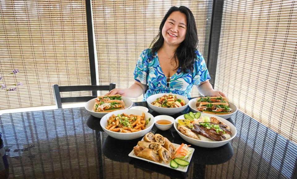 Leila Jace, owner of Sizzle n’ Steam in central Fresno, sits with several of the restaurant’s more popular Vietnamese dishes that reflect her upbringing in this Fresno Bee file photo. CRAIG KOHLRUSS/ckohlruss@fresnobee.com