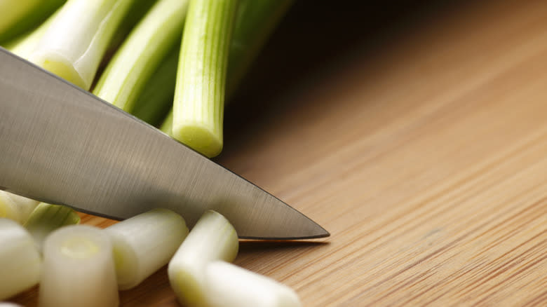 green onion being sliced