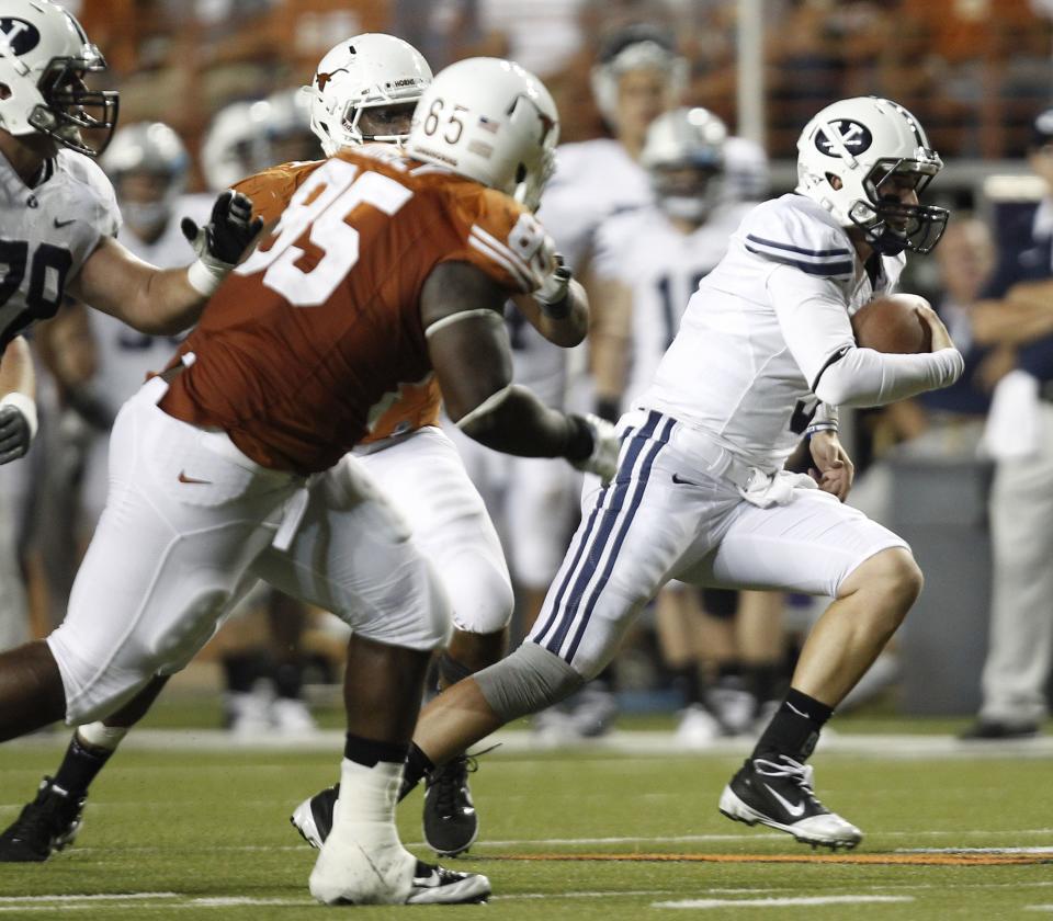 BYU’s Jake Heaps, right, runs with the ball against Texas during a game, Saturday, Sept. 10, 2011, in Austin, Texas. The Longhorns defeated the Cougars, 17-16. | Eric Gay, Associated Press