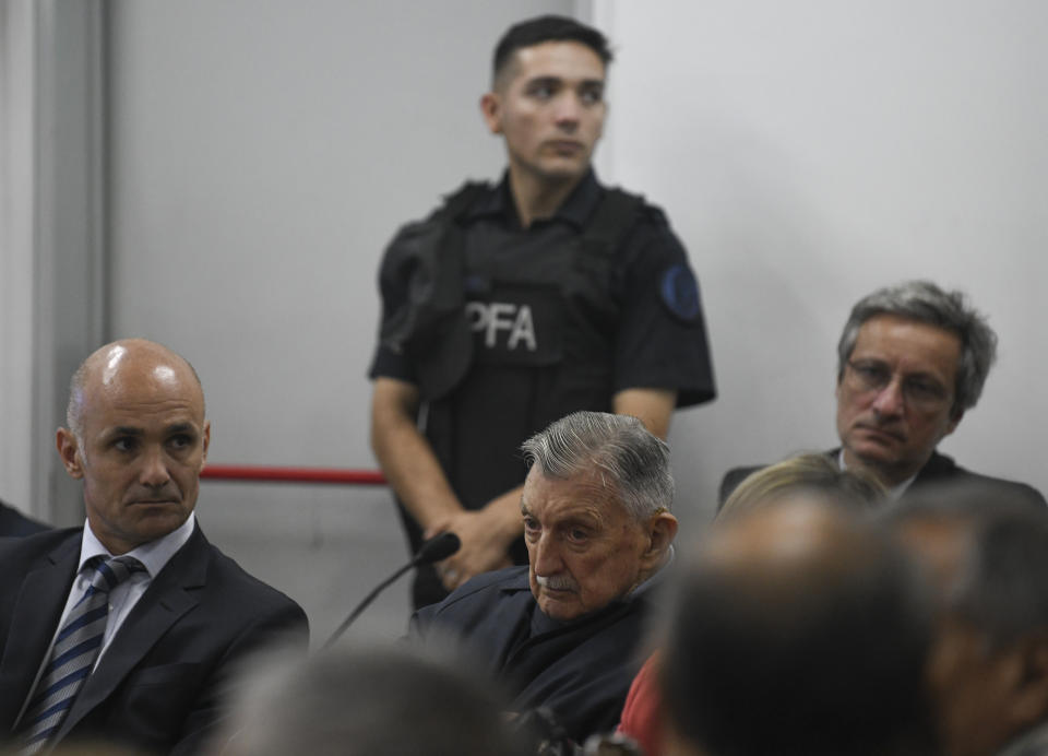 Former Ford Motor Co. executive Hector Sibilla, center, who is charged with crimes against humanity for allegedly targeting Argentine union workers for kidnapping and torture after the country's 1976 military coup, awaits sentencing in Buenos Aires, Argentina, Tuesday, Dec. 11, 2018. (AP Photo/Gustavo Garello)