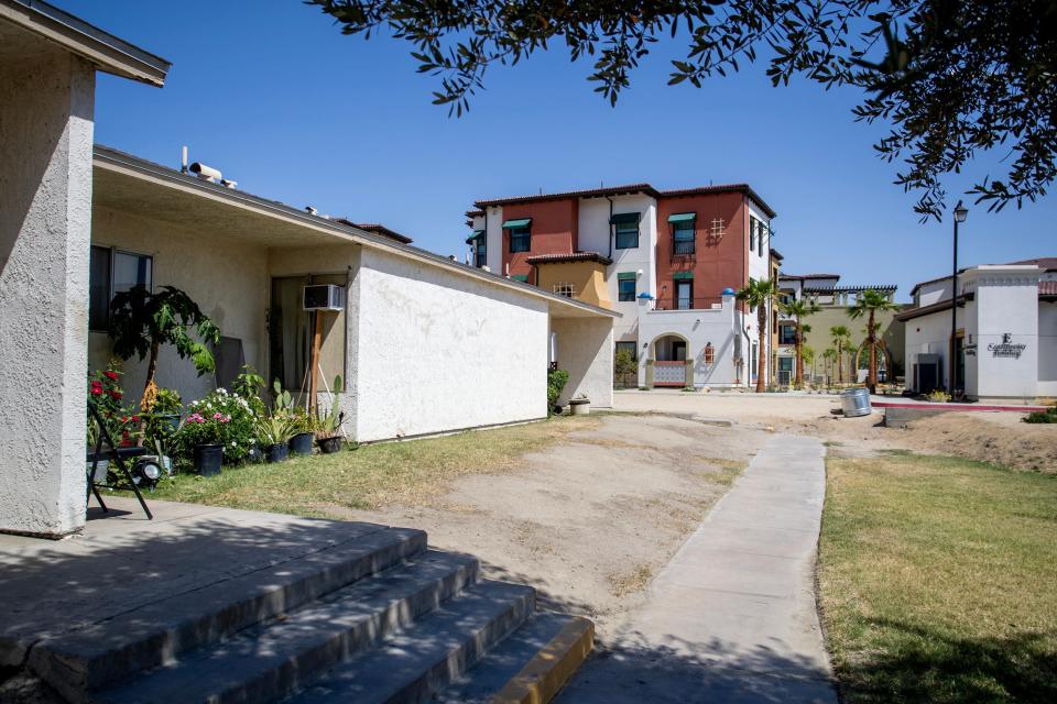 The older Coachella Valley Apartments, left, connect via a sidewalk to the new Placita Dolores Huerta affordable housing complex in Coachella, as seen Thursday.