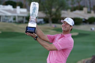 Hudson Swafford lift the winner's trophy at the end of the American Express golf tournament on the Pete Dye Stadium Course at PGA West, Sunday, Jan. 23, 2022, in La Quinta, Calif. (AP Photo/Marcio Jose Sanchez)