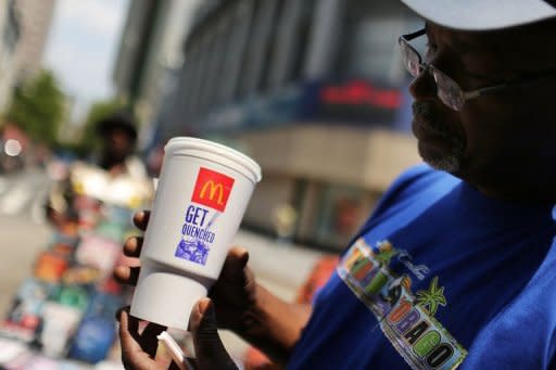 File picture shows a customer with an extra large soft drink from in New York City. New York became the first city in the United States to impose a limited ban on super-sized soda drinks blamed by Mayor Michael Bloomberg for fueling a national obesity crisis