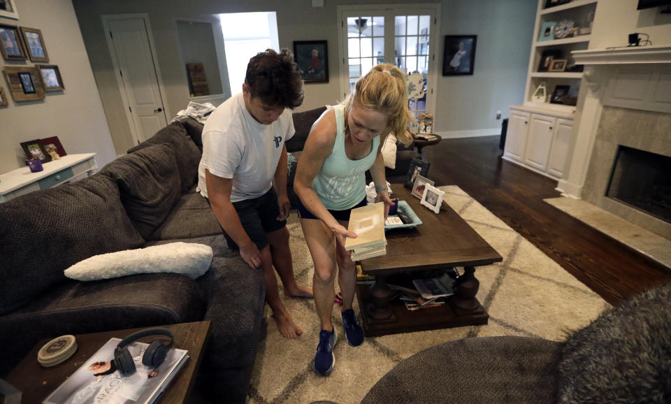 Tiffany Favre, right, and her son, Brandon, use blocks to raise their couch off the floor Friday, July 12, 2019, in Baton Rouge, La., ahead of Tropical Storm Barry. The National Weather Service in New Orleans says water is already starting to cover some low lying roads as Tropical Storm Barry approaches the state from the Gulf of Mexico. (AP Photo/David J. Phillip)