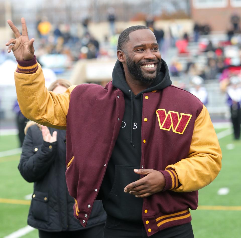 Former Mount Union wide receiver and retired NFL player Pierre Garcon waves to the crowd Saturday, Nov. 11, 2023, after being introduced during halftime of a game. Garcon was inducted as a member of the Class of 2023 of Mount Union's M Club Hall of Fame.