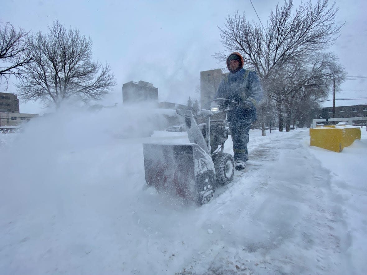 A man uses a snowblower in Regina after more snow falls in the Queen City. (Matthew Howard/CBC - image credit)