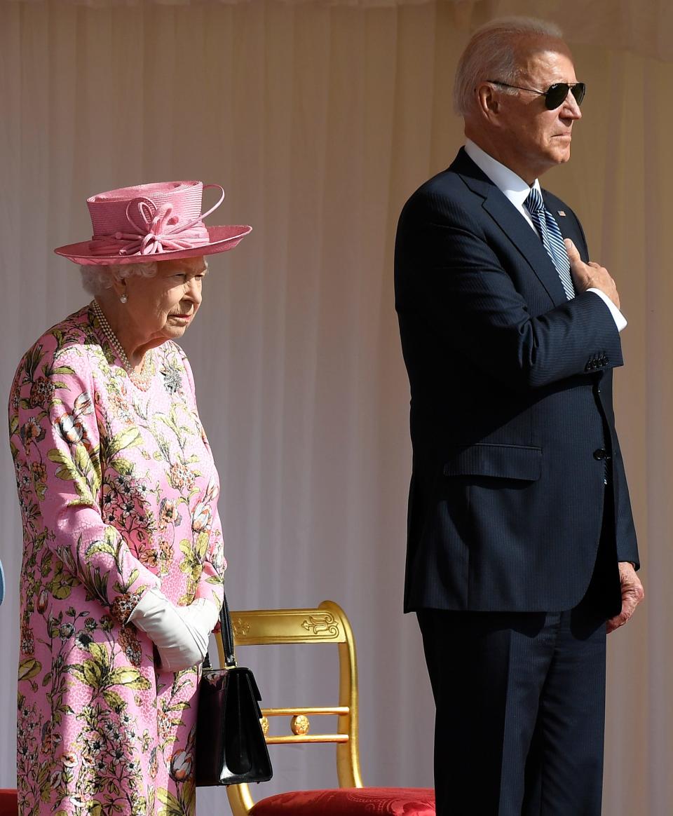 Britain's Queen Elizabeth II stands with US President Joe Biden as they listen to the US national anthem at Windsor Castle near London, Sunday, June 13, 2021. (AP Photo/Alberto Pezzali) ORG XMIT: TH130